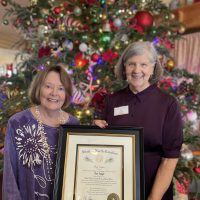 Jane Webster presents the Order of the Long Leaf Pine to Tess Judge. Photo courtesy of the Outer Banks Community Foundation.