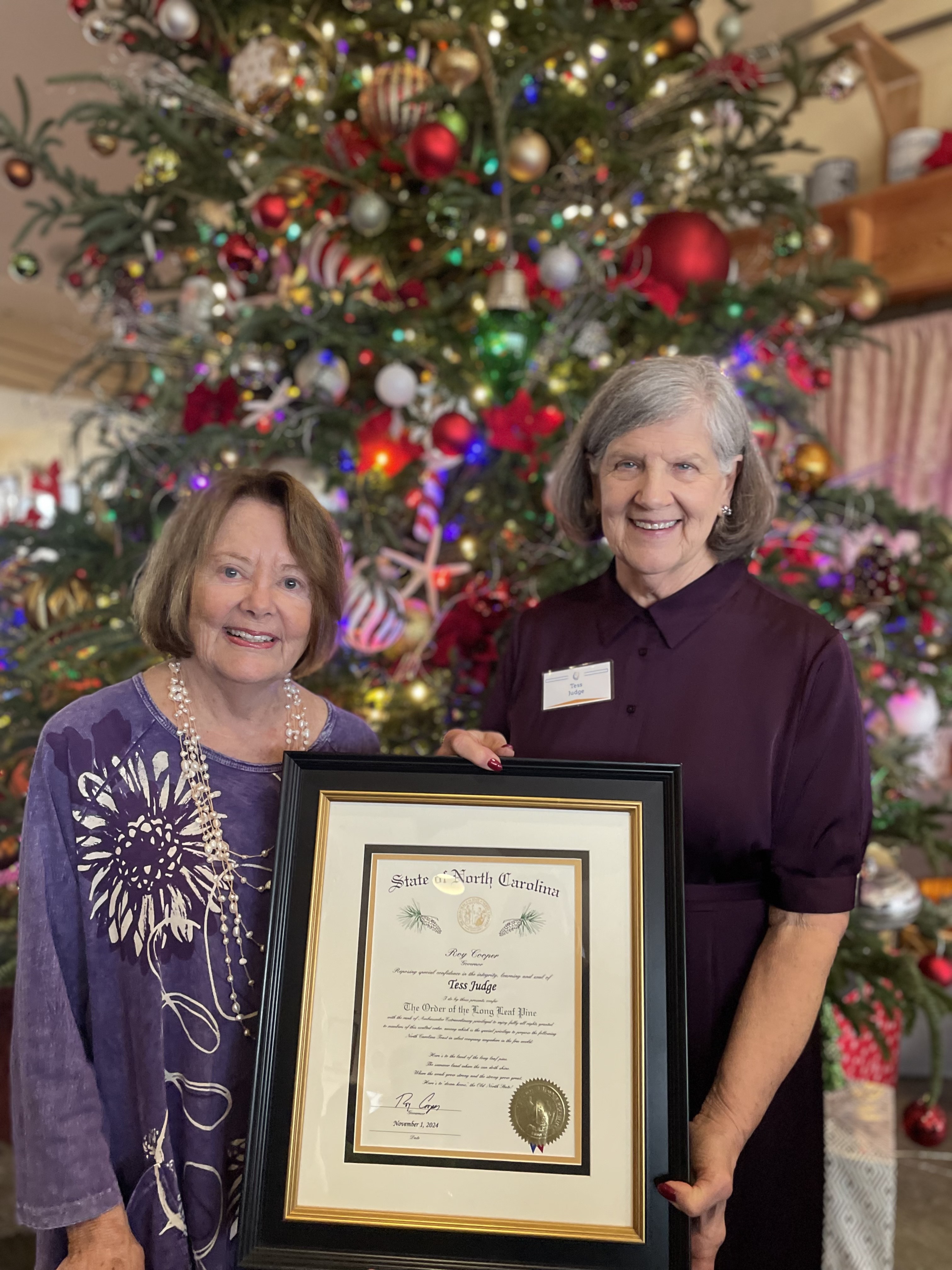 Jane Webster presents the Order of the Long Leaf Pine to Tess Judge. Photo courtesy of the Outer Banks Community Foundation.